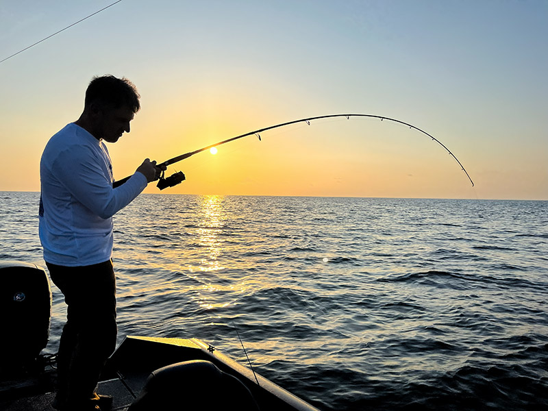 inshore angler battling redfish in lake pontchartrain